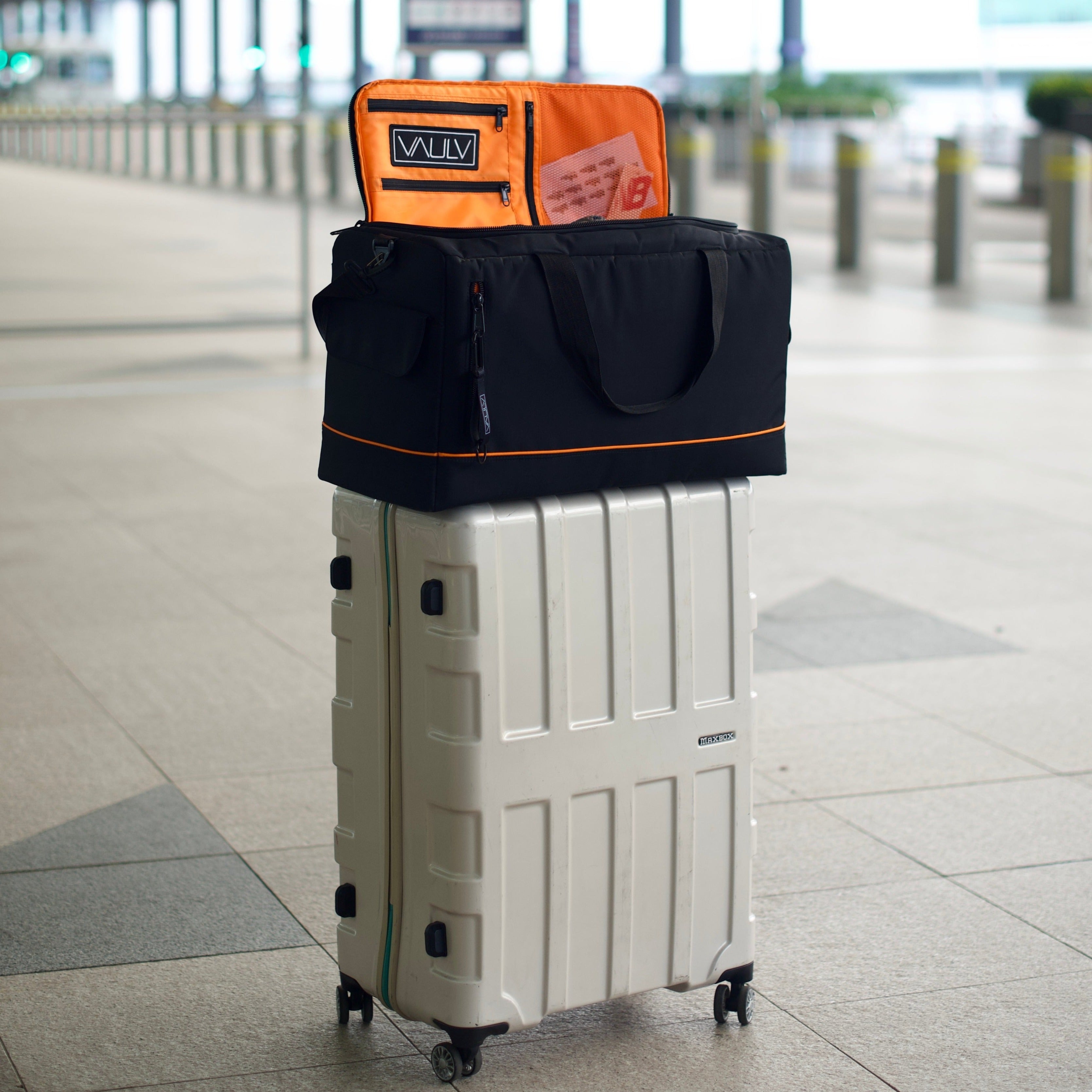 vaulv duffle bag on luggage